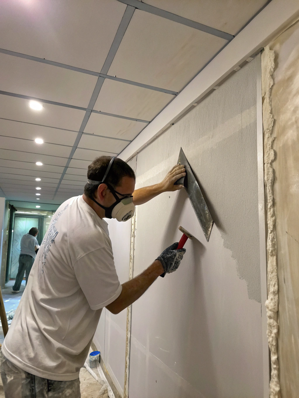 Technician applying Level 5 drywall finish